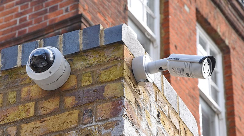 Outdoor CCTV cameras mounted on a brick wall.